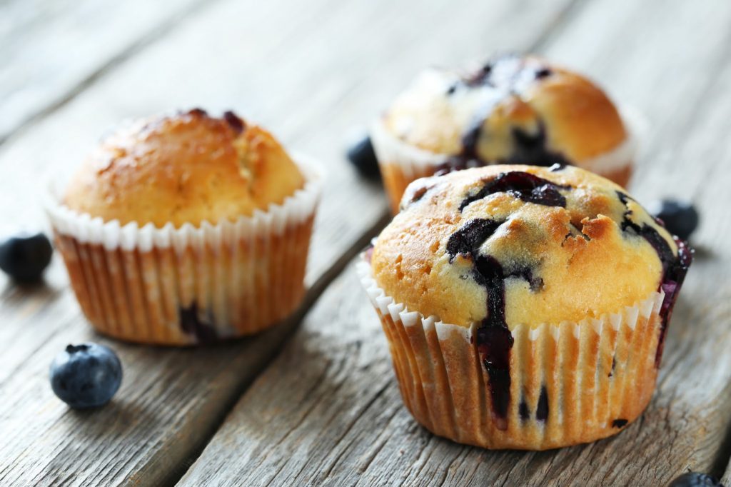 Blueberry Amish Friendship Bread Muffins on a wooden table