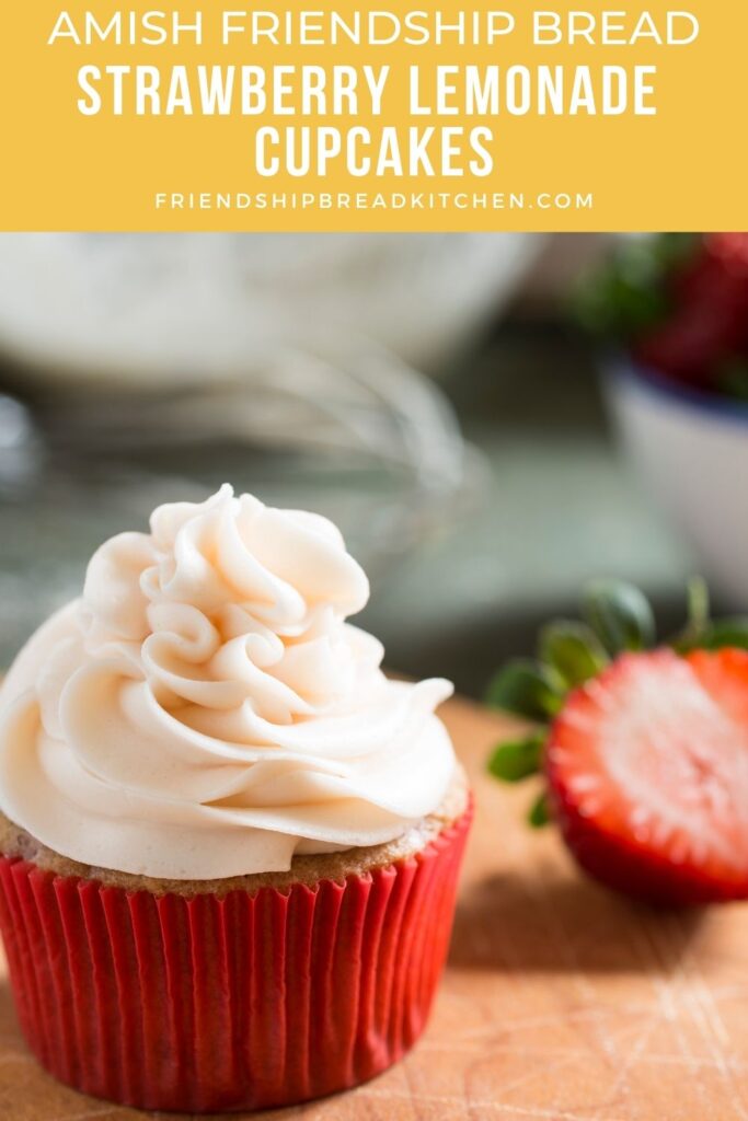 Amish Friendship Bread Strawberry Lemonade Cupcake with strawberry cut in half behind