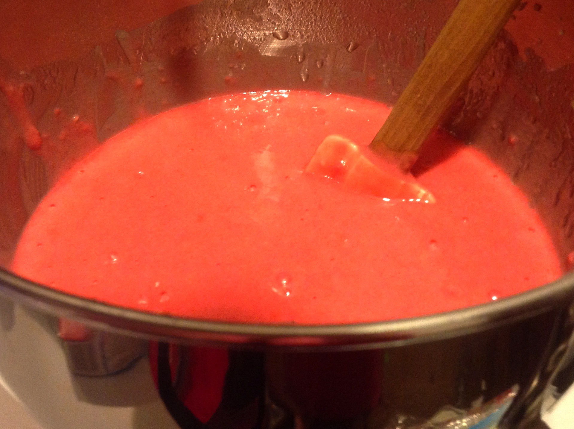 close up of pink batter in a metal bowl