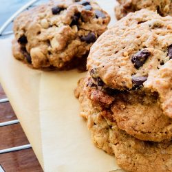 Amish Friendship Bread dump cookies stacked on parchment paper.