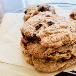 Amish Friendship Bread dump cookies stacked on parchment paper.