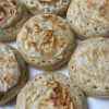 Close up of sourdough crumpets on a white plate.