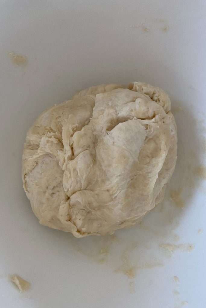 Ball of sourdough cracker dough in a mixing bowl.