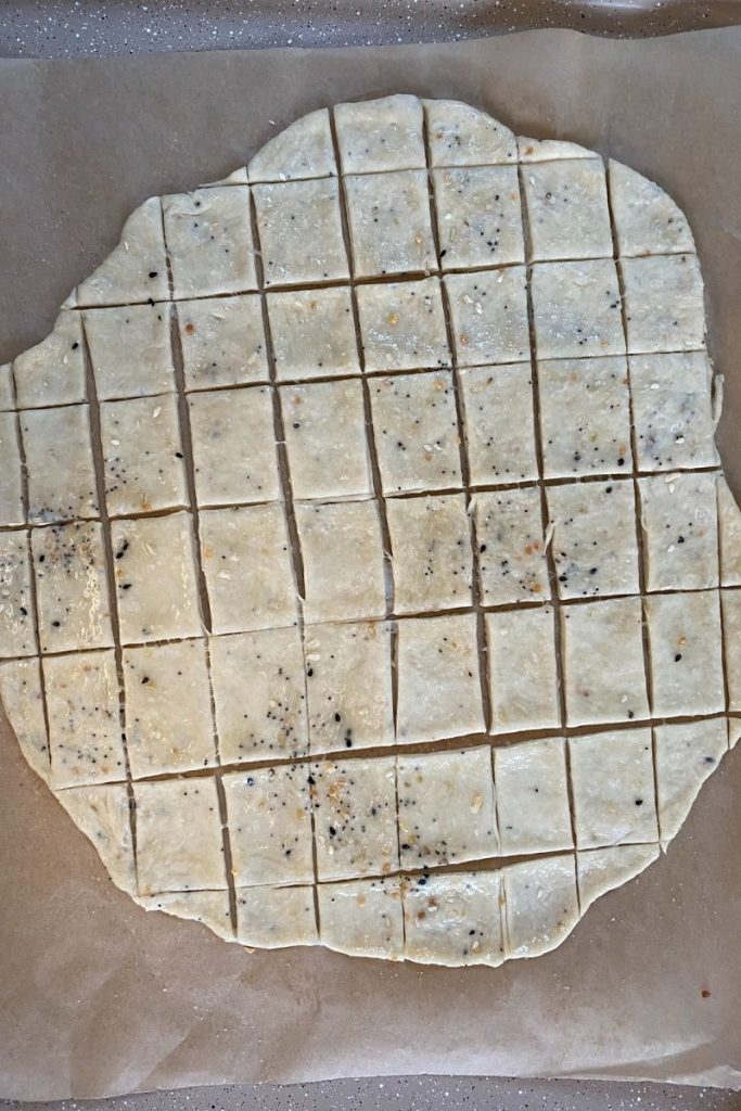 Cracker dough cut into squares.