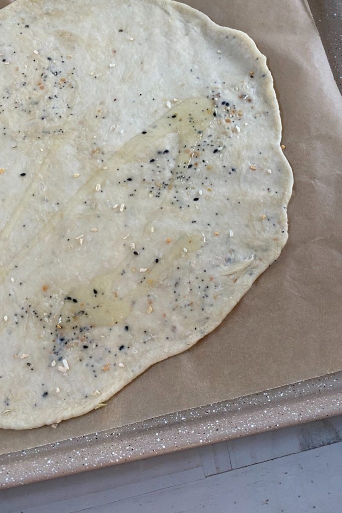 Thin dough covered with olive oil and seeds.